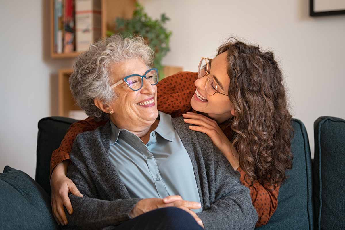 an image of an adult child hugging their mother